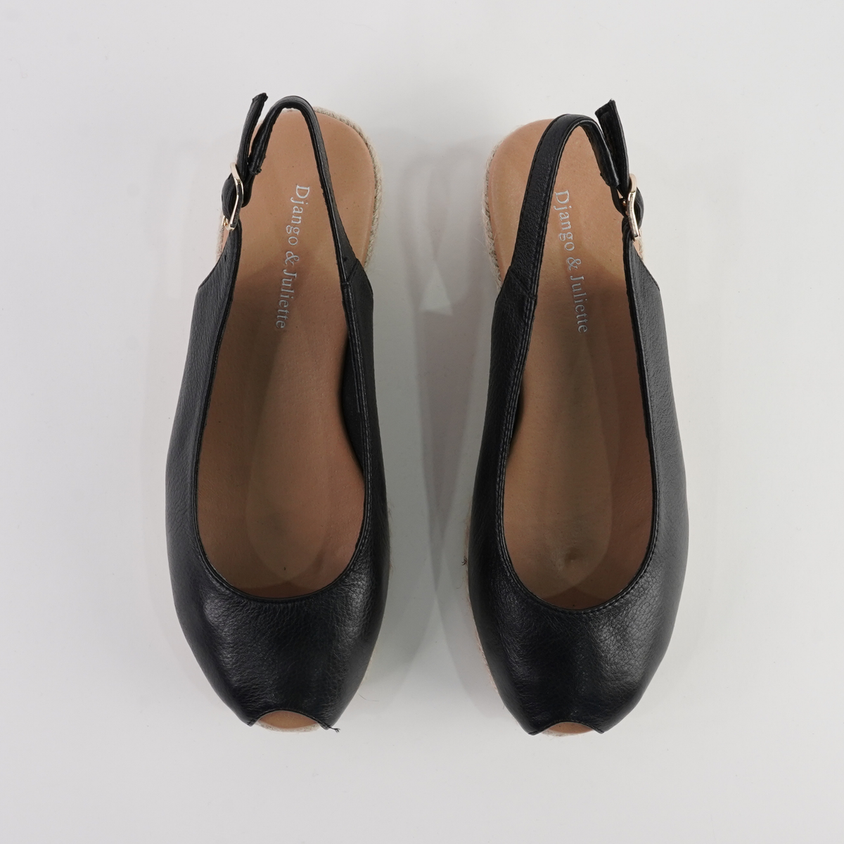 Black leather espadrille wedges by Django and Juliette, featuring a stylish design and comfortable platform sole.