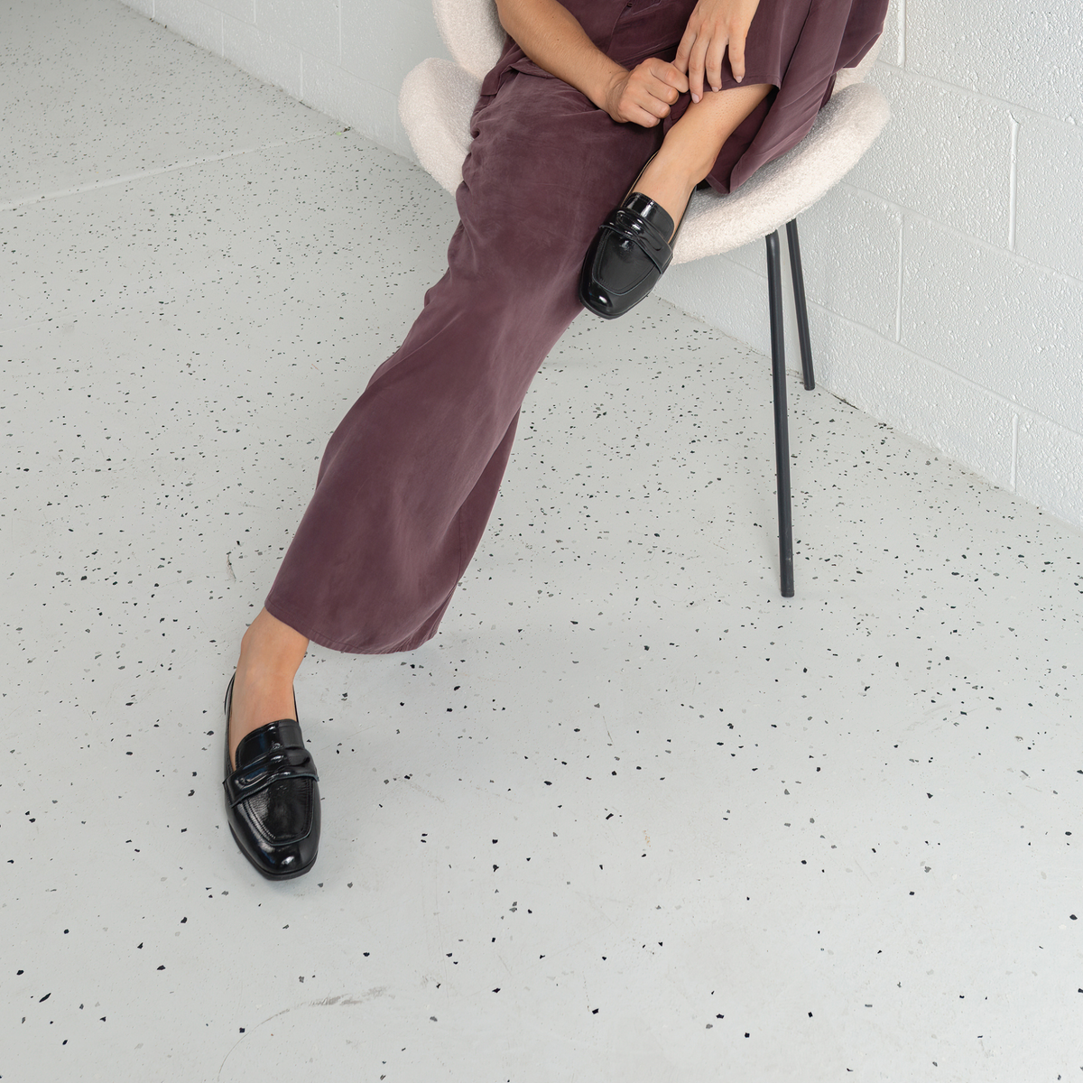 Black patent leather loafers for women by SALA, featuring a sleek design and comfortable fit for casual wear.